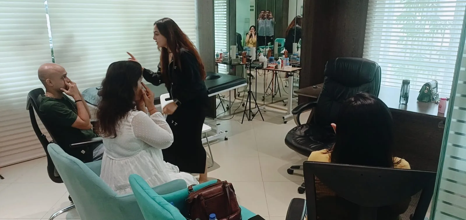 Vibha Jain speaking with people seated in a calm consulting room during an initial conversation.